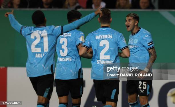 Bayer Leverkusen's Argentine midfielder Exequiel Palacios celebrates scoring the opening goal from the penalty spot with his teammates during the...