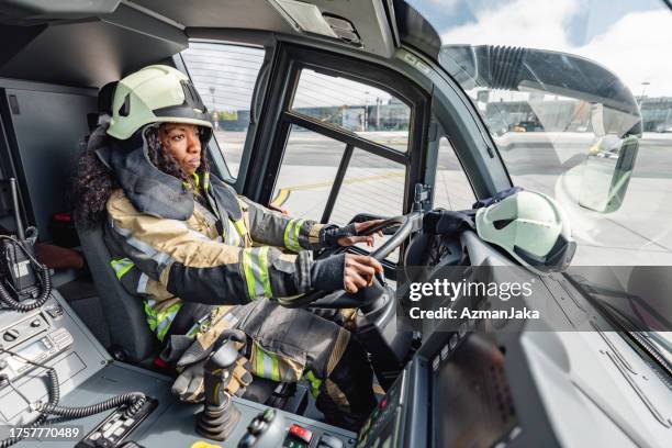 confident african-american female firefighter - firefighter getting dressed stock pictures, royalty-free photos & images