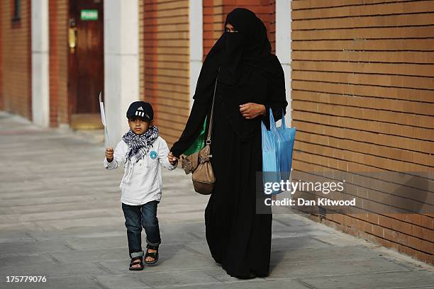 Members of the Muslim community arrive to pray at the East London Mosque on the last day of Ramadan on August 7, 2013 in London, England. The holy...