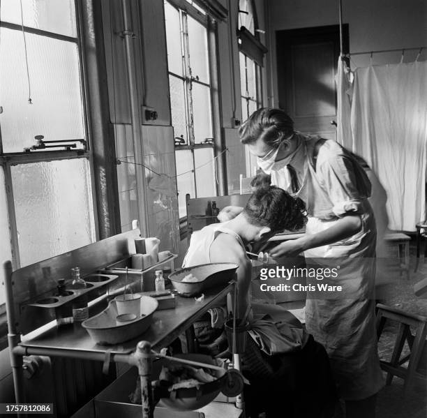 Doctor treating a patient for a shoulder injury in the 'back surgery' at Guy's Hospital in Southwark, London, England, February 1948.