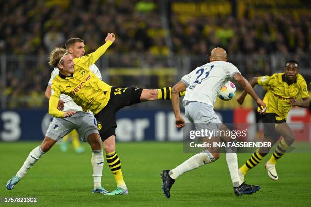 Hoffenheim's German midfielder Grischa Proemel, Dortmund's German midfielder Julian Brandt and Hoffenheim's German defender John Anthony Brooks vie...
