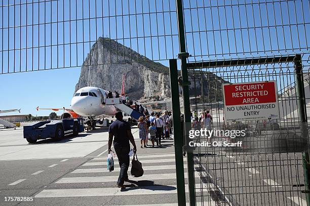 Passengers board a flight at Gibraltar International Airport on August 8, 2013 in Gibraltar. David Cameron has spoken with his Spanish counterpart,...