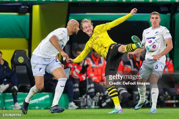 John Anthony Brooks of TSG 1899 Hoffenheim and Julian Brandt of Borussia Dortmund battle for the ball during the DFB cup second round match between...