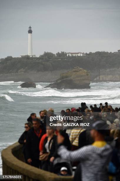 Members of the public look at waves, as the Biarritz lighthouse is seen in the background, at the Grande Plage ahead of storm Ciaran hitting the...