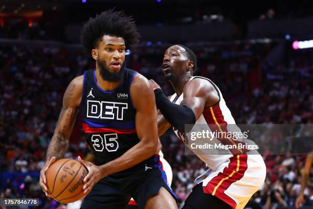 Marvin Bagley III of the Detroit Pistons drives against Bam Adebayo of the Miami Heat during the third quarter of the game at Kaseya Center on...