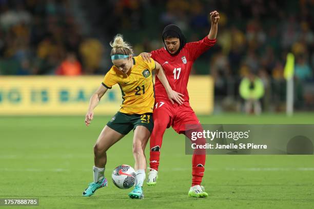 Ellie Carpenter of the Matildas contests the ball against Mohaddeseh Zolfi of the Islamic Republic of Iran during the AFC Women's Asian Olympic...