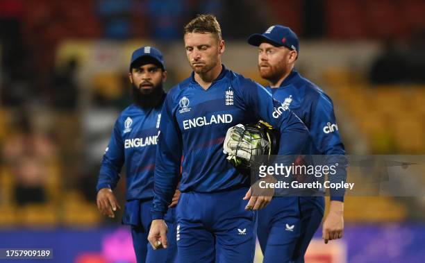 Adil Rashid, Jonny Bairstow and Jos Buttler of England cut dejected figures following the ICC Men's Cricket World Cup India 2023 between England and...