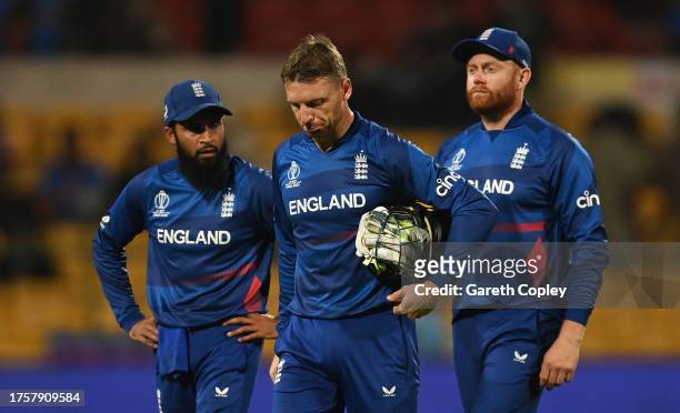 Adil Rashid, Jonny Bairstow and Jos Buttler of England cut dejected figures following the ICC Men's Cricket World Cup India 2023 between England and...