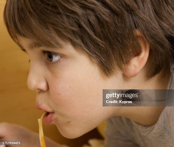 male child age eight years - child eating cereal stock pictures, royalty-free photos & images