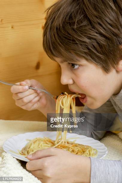 male child age eight years - child eating cereal stock pictures, royalty-free photos & images