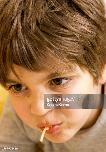 male child age eight years - child eating cereal stock pictures, royalty-free photos & images