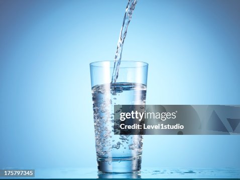 Cold drink water being poured into glass Cold drink water being poured into glass