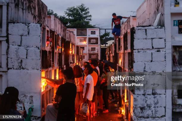 People visit the grave of their loved ones in Antipolo City, Philippines on November 1, 2023. All Soul's Day, locally known as Araw Ng Mga Patay or...