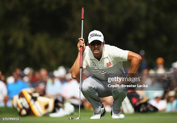 Adam Scott of Australia lines up his putt for birdie on the eighth hole during the first round of the 95th PGA Championship on August 8, 2013 in...