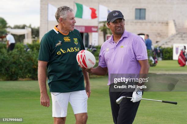 James Kingston of South Africa meets up with Michael Campbell of New Zealand on the range for a rugby challenge during Day One of the Sergio...