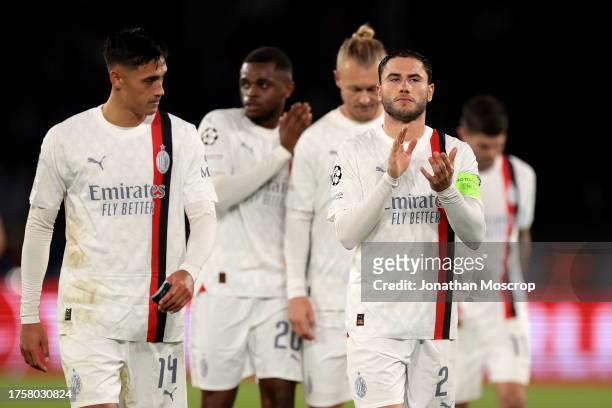 Davide Calabria of AC Milan leads team mates to applaud the fans following the final whistle of the UEFA Champions League match between Paris...