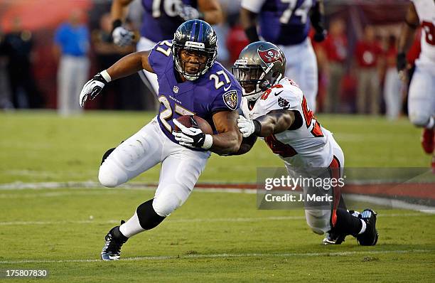 Running back Ray Rice of the Baltimore Ravens is tackled by linebacker Lavonte David of the Tampa Bay Buccaneers during a preseason game at Raymond...