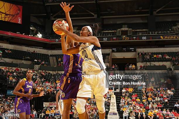 Briann January of the Indiana Fever battles A'dia Mathies of the Los Angeles Sparks on August 8, 2013 at Bankers Life Fieldhouse in Indianapolis,...