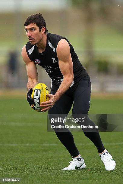 Quinten Lynch looks to pass during a Collingwood Magpies AFL training session at Olympic Park on August 9, 2013 in Melbourne, Australia.