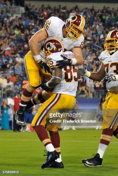 Logan Paulsen of the Washington Redskins congratulates teammate Leonard Hankerson on scoring a touchdown against the Tennessee Titans during a...