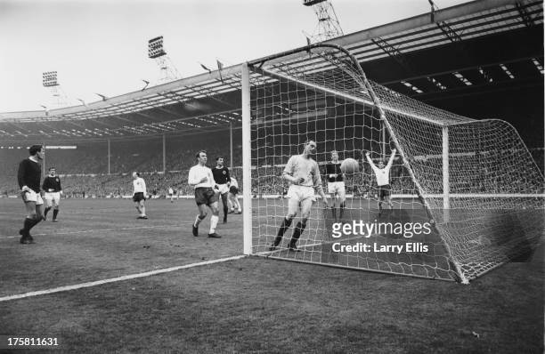 Scottish goalkeeper Ronnie Simpson fails to save a goal from Geoff Hurst during an England V Scotland match at Wembley, London, 15th April 1967. Also...