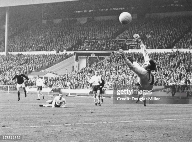 England goalkeeper Gordon Banks saves a shot from Denis Law during an England V Scotland match at Wembley, London, while Nobby Stiles looks on from...