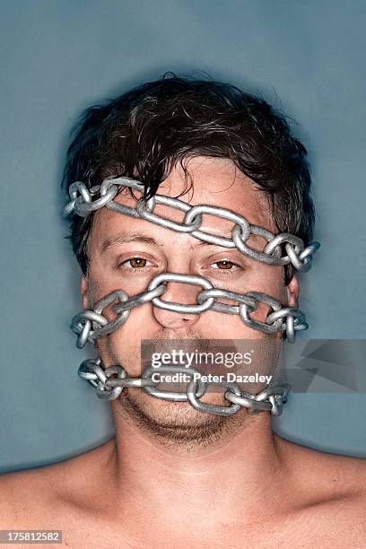 mans face wrapped in chains - servidão imagens e fotografias de stock