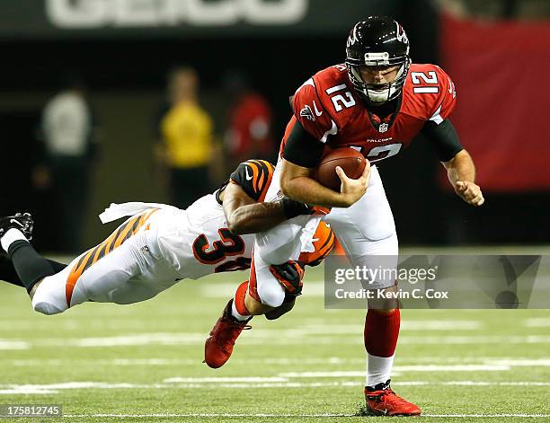 Shaun Prater of the Cincinnati Bengals tackles Sean Renfree of the Atlanta Falcons at Georgia Dome on August 8, 2013 in Atlanta, Georgia.