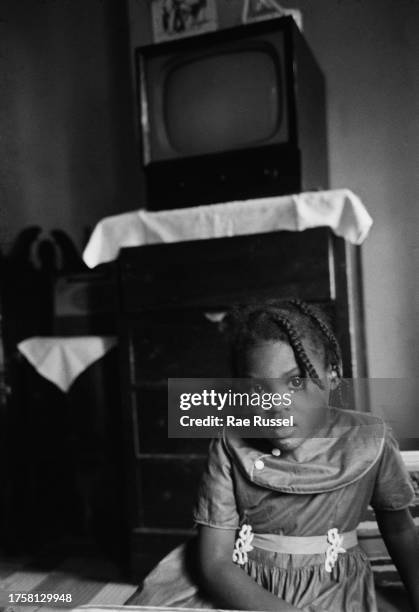 Young girl with braided hair in a property at a social housing development on Henry Street in the Lower East Side of Manhattan, New York City, New...