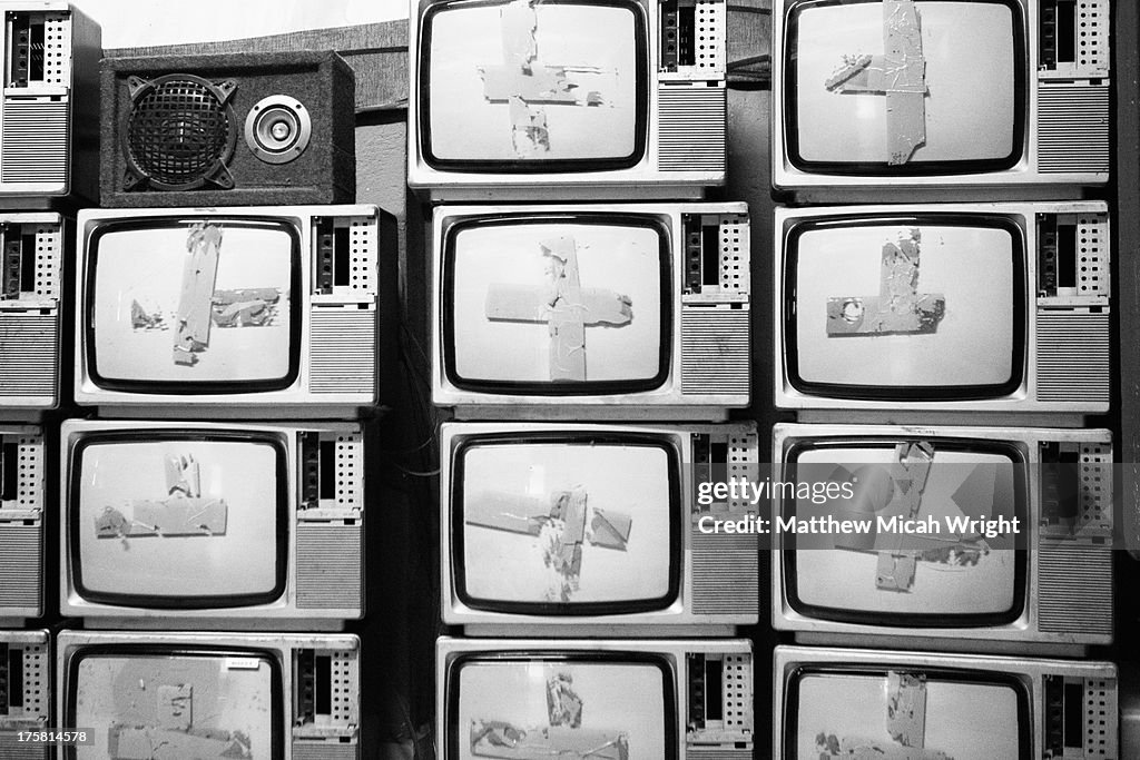 Old televisions stacked together in formation