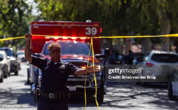 Van Nuys, CA A Los Angeles Unified School District police officer lifts police tape to let an ambulance leave the scene following a stabbing injuring...