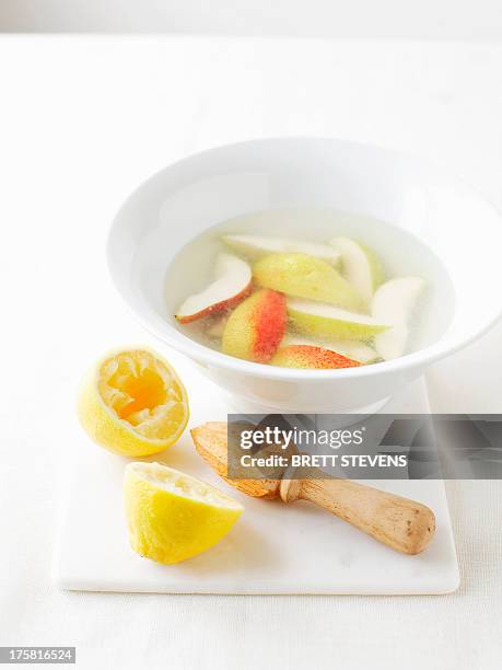 bowl of water with lemon juice to prevent vegetables from browning - lemon juice stock pictures, royalty-free photos & images
