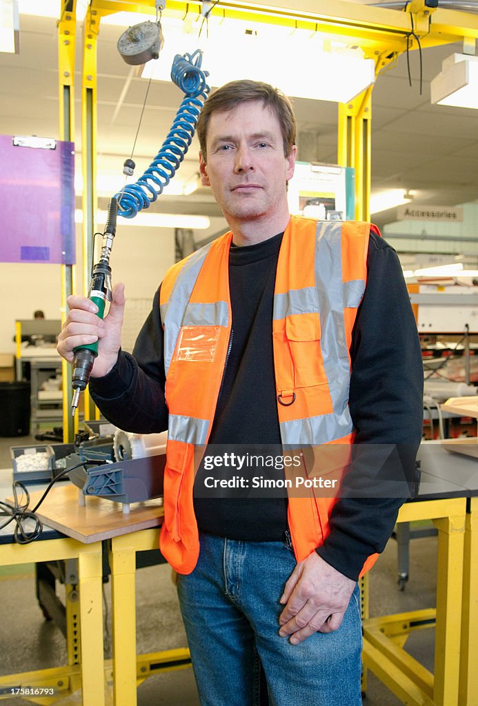 Man with machinery in electrical component factory