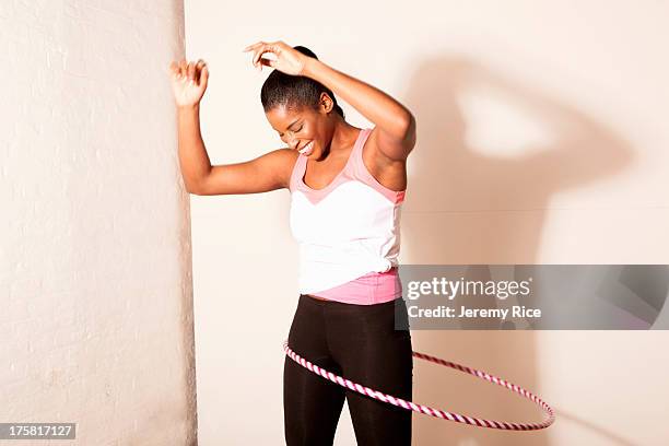 portrait of young woman using plastic hoop - plastic hoop stock pictures, royalty-free photos & images