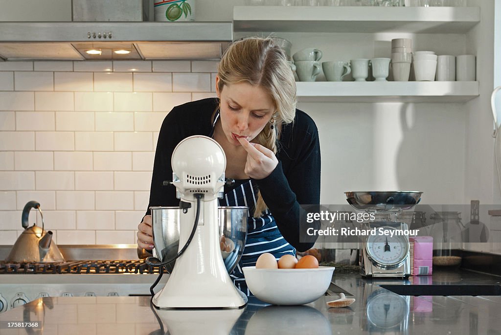 Woman tasting dough mix