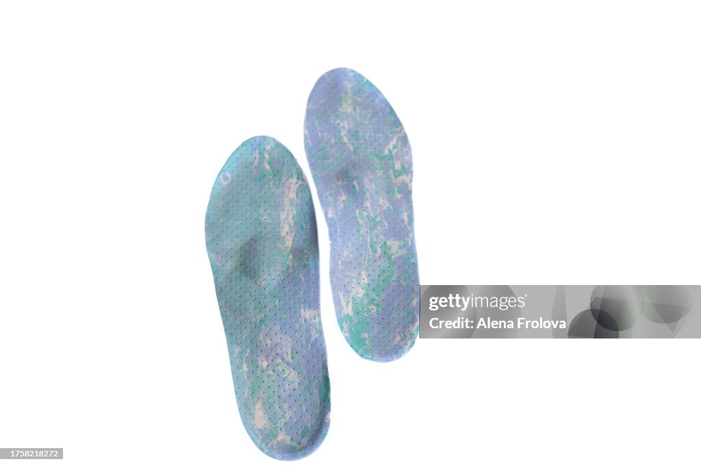 A pairof orthopedic shoe insoles on a white background