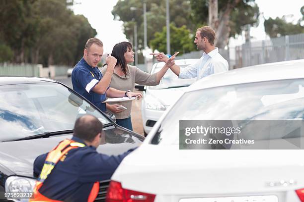 drivers accusing each other at scene of car accident - row police stock pictures, royalty-free photos & images