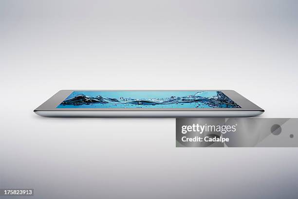 digital tablet with gently rising bubbling water on screen - cadalpe stock pictures, royalty-free photos & images