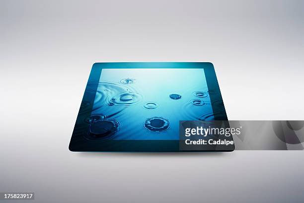 digital tablet with water drop effect on screen - cadalpe stock pictures, royalty-free photos & images