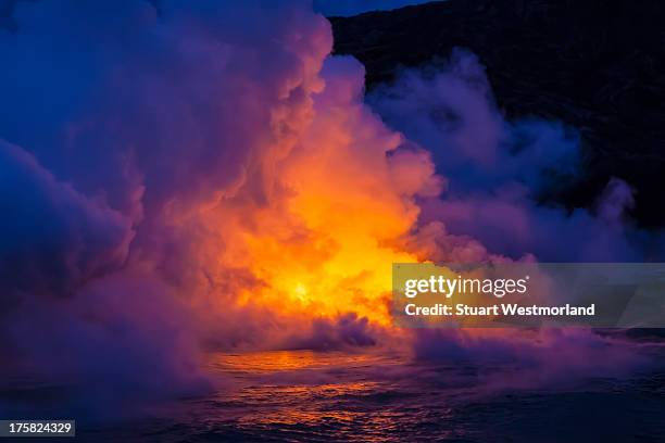 smoke clouds from lava flow impacting sea at dusk, kilauea volcano, hawaii - erupting stock pictures, royalty-free photos & images