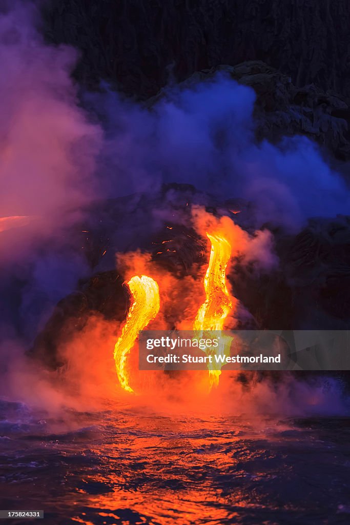 Lava flow impacting sea at dusk, Kilauea volcano, Hawaii