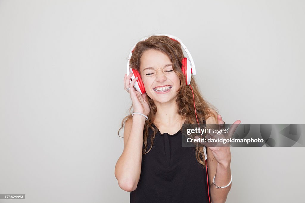Girl wearing headphones with eyes closed