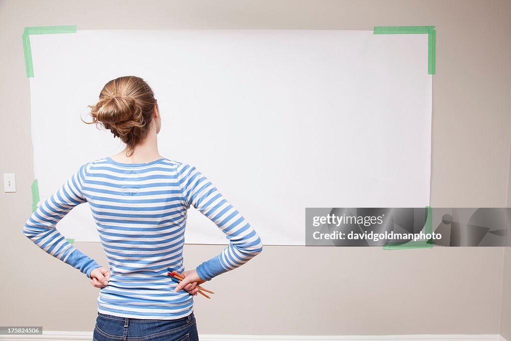 Girl looking at blank space on wall