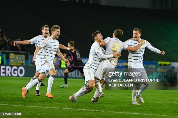 Saarbruecken's players celebrate after winning the German Cup second round football match 1 FC Saarbruecken v FC Bayern Munich at Ludwigspark stadium...