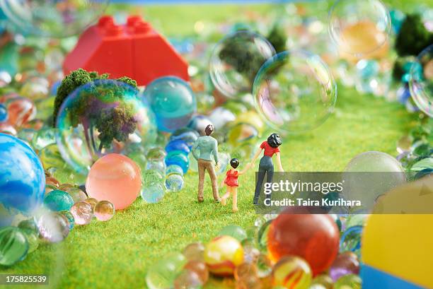 figurines pretend grass with marbles - menschliche darstellung stock-fotos und bilder