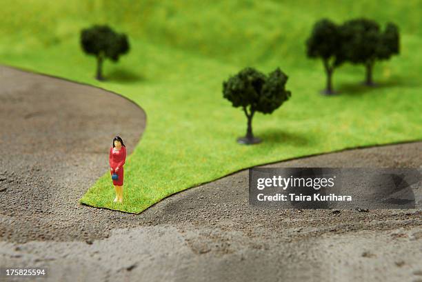 figurine on pretend grass with trees - kleine boom stockfoto's en -beelden