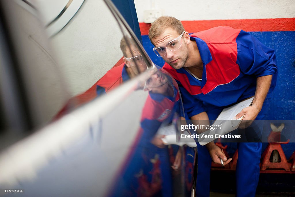 Car mechanic at work in service bay