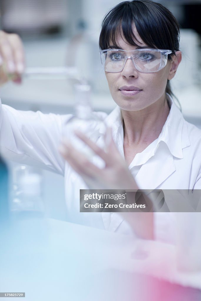 Oenologist mixing during sample testing in laboratory