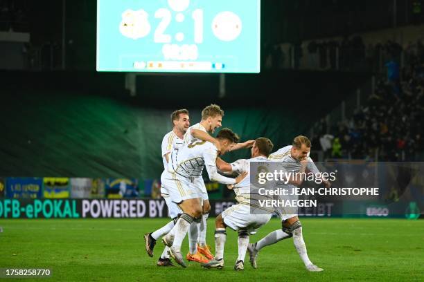 Saarbruecken's players celebrate after winning the German Cup second round football match 1 FC Saarbruecken v FC Bayern Munich at Ludwigspark stadium...