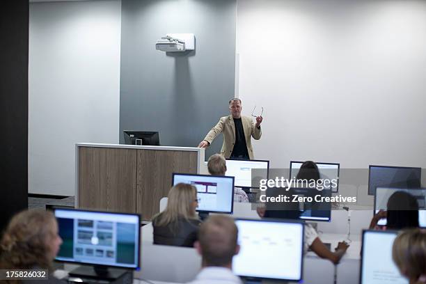 students using computers in lecture - teachers white university stock pictures, royalty-free photos & images